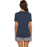 Back view of woman wearing Babe Beachwear navy lounge shirt and short set with striped shorts