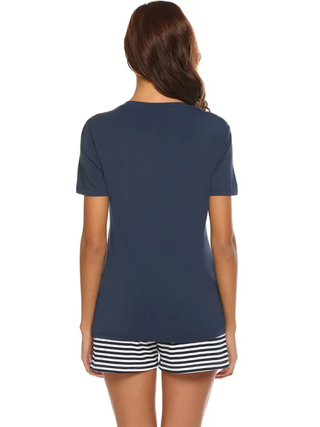 Back view of woman wearing Babe Beachwear navy lounge shirt and short set with striped shorts