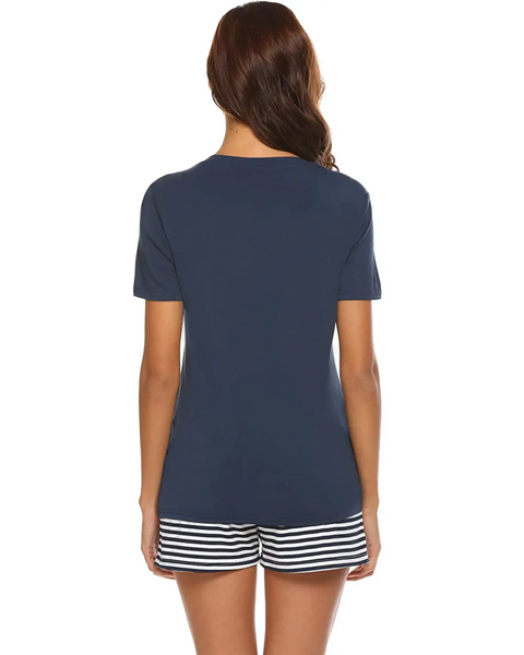 Back view of woman wearing Babe Beachwear navy lounge shirt and short set with striped shorts