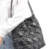 Babe Beachwear luxe chic quilted tote bag in black worn over shoulder with adjustable straps