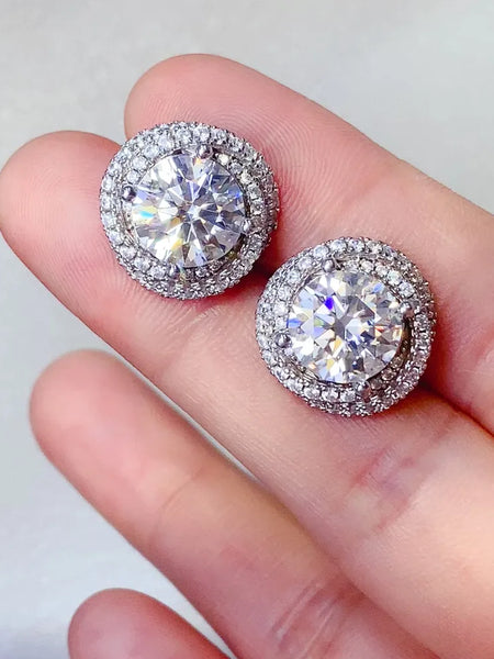 Trendsi 6 carat Stud Diamond Sterling Silver earrings held between fingers with sparkling round stones