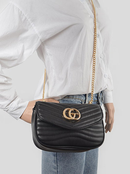 Luxury GC Logo Chain Flap Bag in black leather with gold hardware worn crossbody