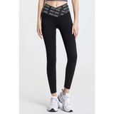Babe Beachwear black high waisted workout leggings for women with branded waistband and white athletic shoes