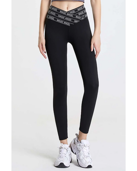 Babe Beachwear black high waisted workout leggings for women with branded waistband and white athletic shoes