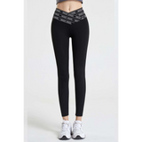Babe Beachwear black high waisted workout leggings for women with branded waistband and white sneakers