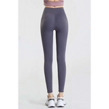 Babe Beachwaer high waisted workout leggings for women in dark gray shown from the back with white sneakers
