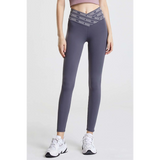 Babe Beachwaer high waisted workout leggings for women in gray with crisscross waistband and white sneakers