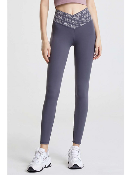 Babe Beachwaer high waisted workout leggings for women in gray with crisscross waistband and white sneakers