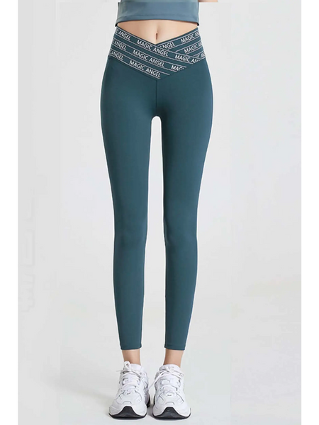 Babe Beachwear high waisted workout leggings for women in teal with logo waistband and white sneakers