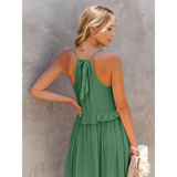 Trendsi flowy pink ruffle maxi dress worn by woman showing back design with tie straps and ruffle detail