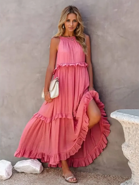 woman in a long pink maxi dress in a pink garden with pink skyline