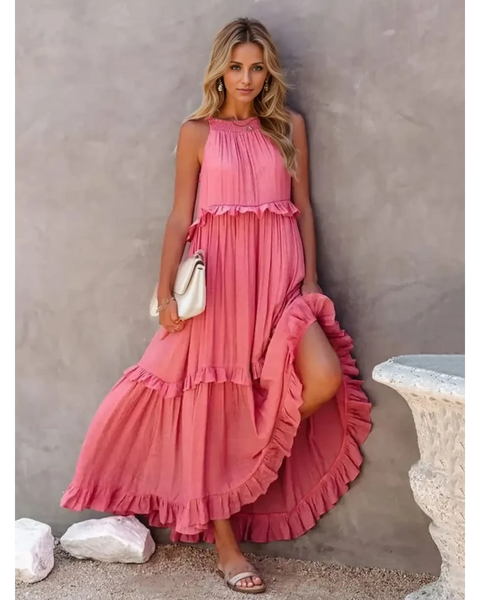 woman in a long pink maxi dress in a pink garden with pink skyline
