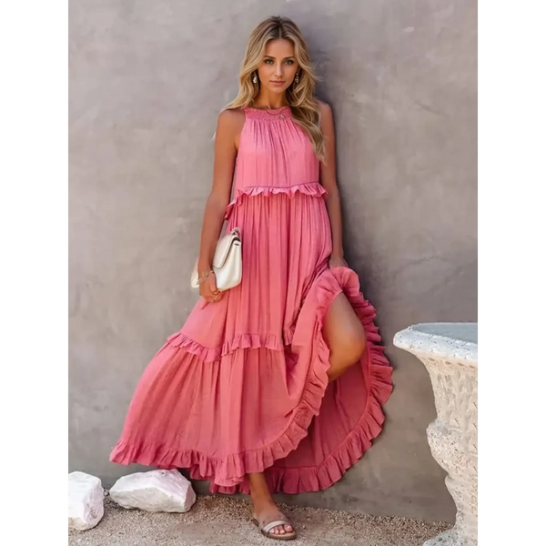 woman in a long pink maxi dress in a pink garden with pink skyline