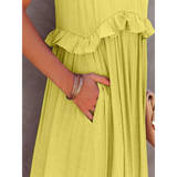 Close-up of hand in pocket on flowy pink ruffle maxi dress from Trendsi with soft fabric texture