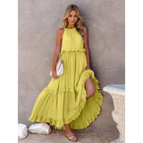 Trendsi flowy pink ruffle maxi dress styled with a white handbag and sandals
