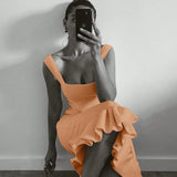 Trendsi orange maxi mermaid dress with ruffled hem and square neckline worn by woman taking a mirror selfie
