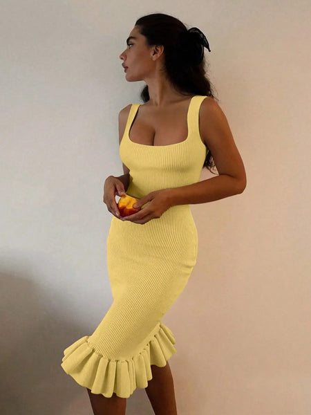 Trendsi yellow sleeveless maxi mermaid dress with ruffle hem worn by woman holding fruit