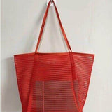 Red Mesh Beach Bag Tote Bag with long handles by Babe Beachwaer hanging on wall hook