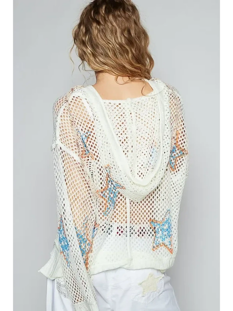 Back view of a white mesh long sleeve summer knit top with star patterns worn by a model