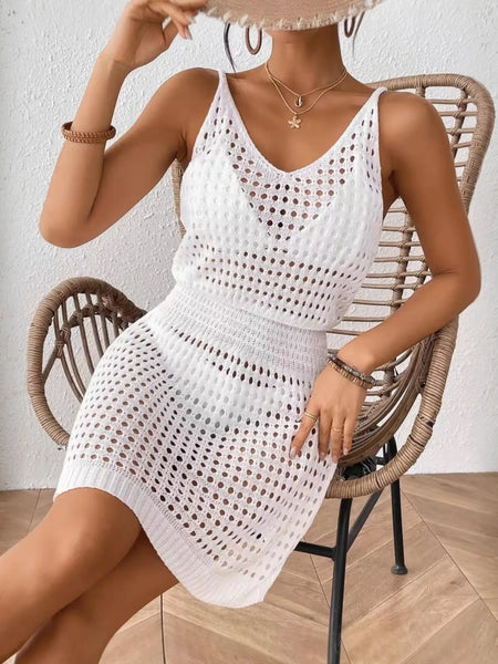 White mesh swimsuit coverup mini dress by Babe Beachwear worn by woman sitting on wicker chair