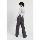Woman wearing dark gray relaxed cargo pants for women with large pockets styled with a striped long-sleeve shirt