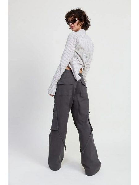 Woman wearing dark gray relaxed cargo pants for women with large pockets styled with a striped long-sleeve shirt
