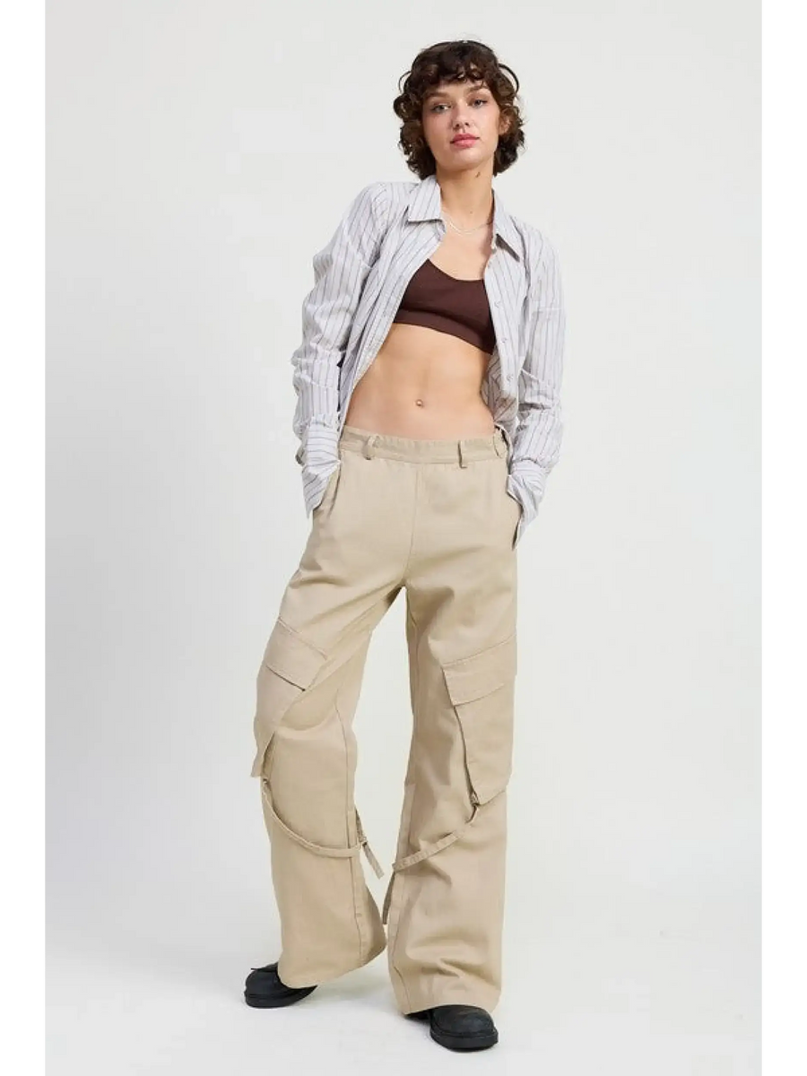 Woman wearing beige relaxed cargo pants for women with pockets, paired with striped shirt and black shoes