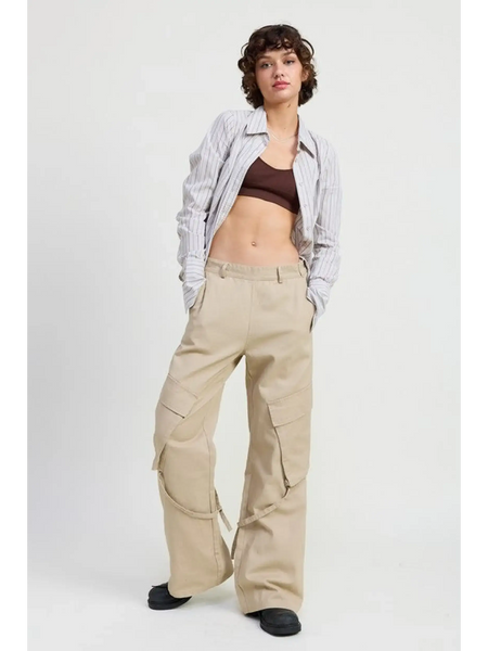 Woman wearing beige relaxed cargo pants for women with pockets, paired with striped shirt and black shoes