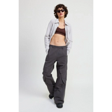 Woman wearing relaxed cargo pants for women in dark gray paired with crop top and striped shirt