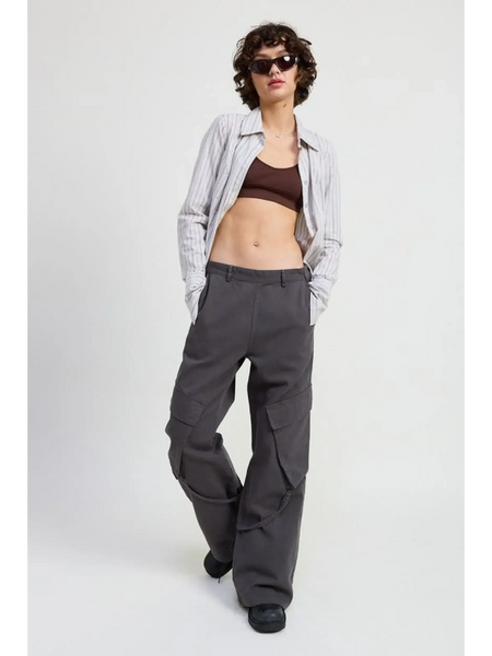 Woman wearing relaxed cargo pants for women in dark gray paired with crop top and striped shirt
