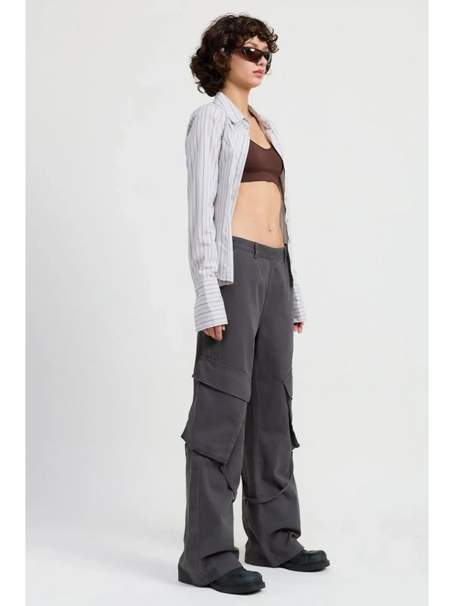Emory Park relaxed cargo pants for women in dark gray worn with crop top and striped overshirt