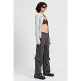 Emory Park relaxed cargo pants for women in dark gray worn with crop top and striped overshirt