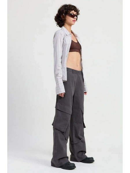 Emory Park relaxed cargo pants for women in dark gray worn with crop top and striped overshirt