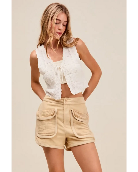 Trendsi beige High Rise Cargo Shorts with large front pockets worn with white sleeveless top