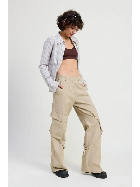 Woman wearing beige relaxed cargo pants for women with a striped shirt and dark crop top