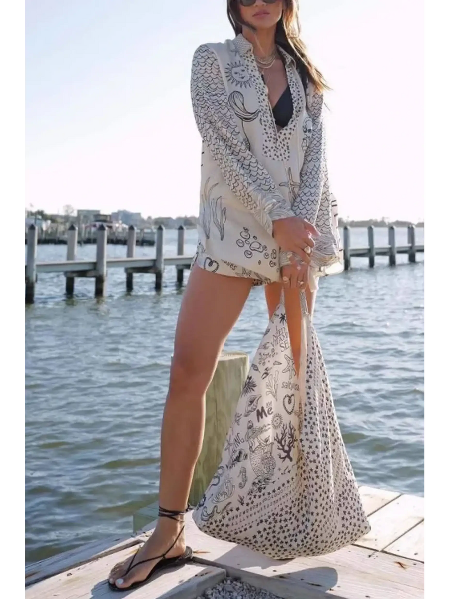 Trendsi Nautical Print Top and Shorts Set worn by a woman standing on a dock by the water