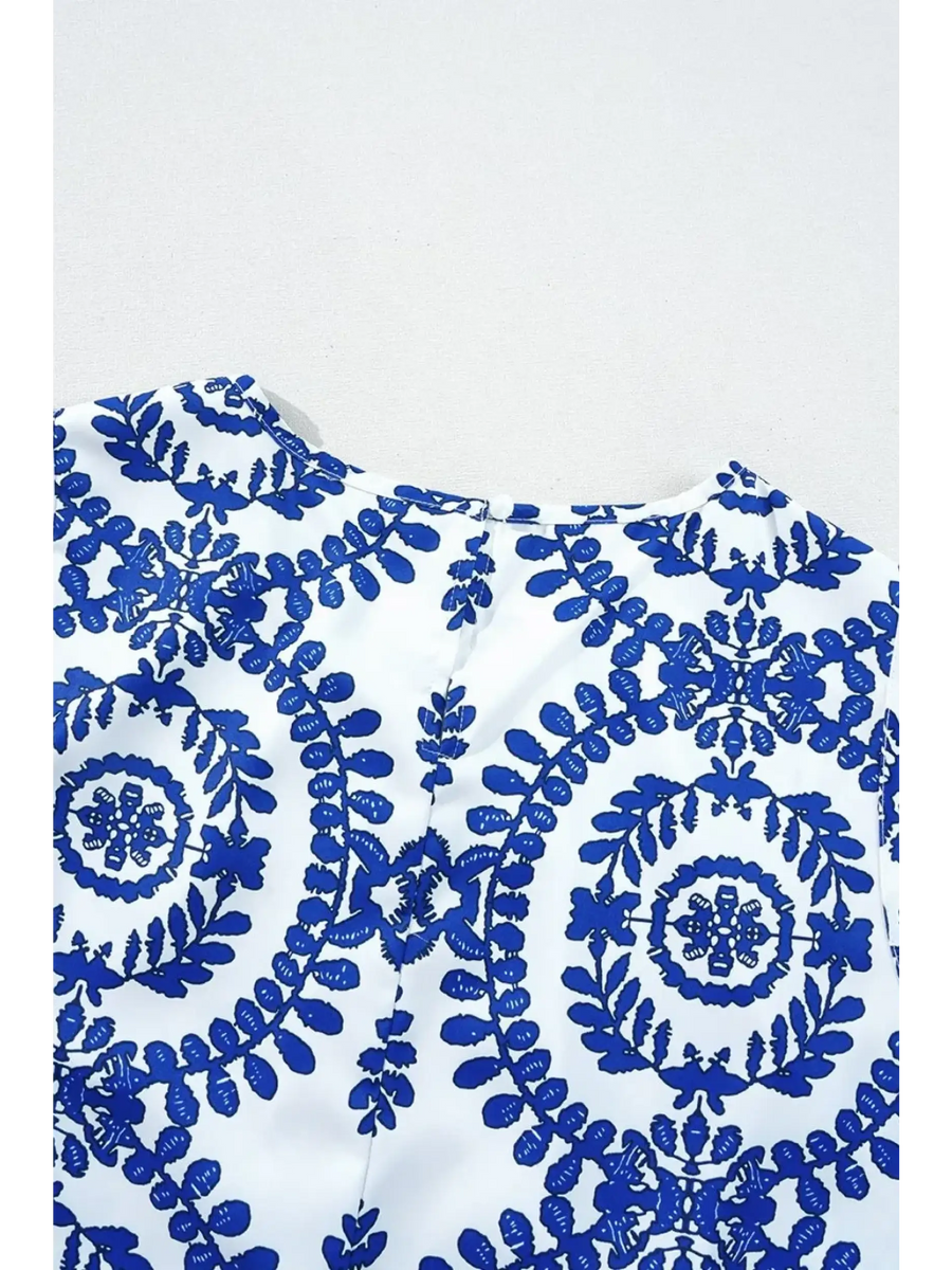Navy blue sleeveless top for women with intricate floral embroidery on white fabric by Trendsi