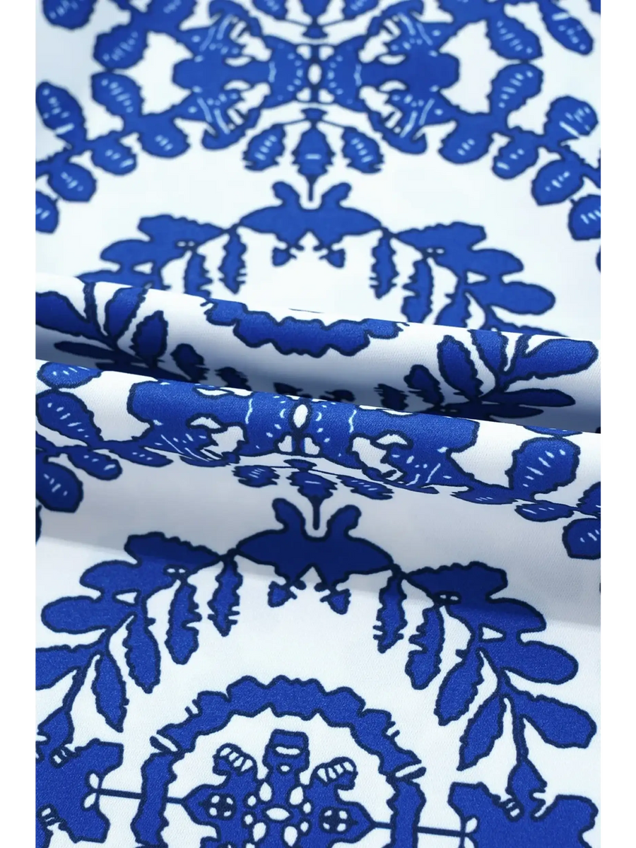 Close-up of fabric pattern on navy blue sleeveless top for women from Trendsi featuring intricate blue designs on white background