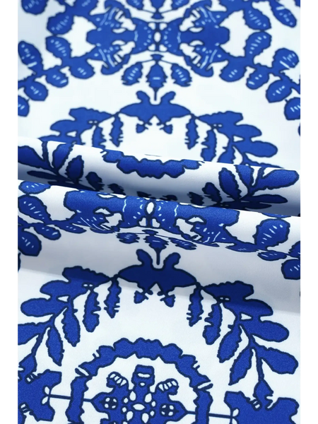 Close-up of fabric pattern on navy blue sleeveless top for women from Trendsi featuring intricate blue designs on white background