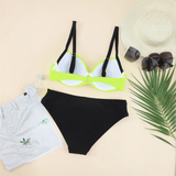 Trendsi neon bikini set with black bottoms and neon yellow top with black straps styled with white shorts hat and sunglasses