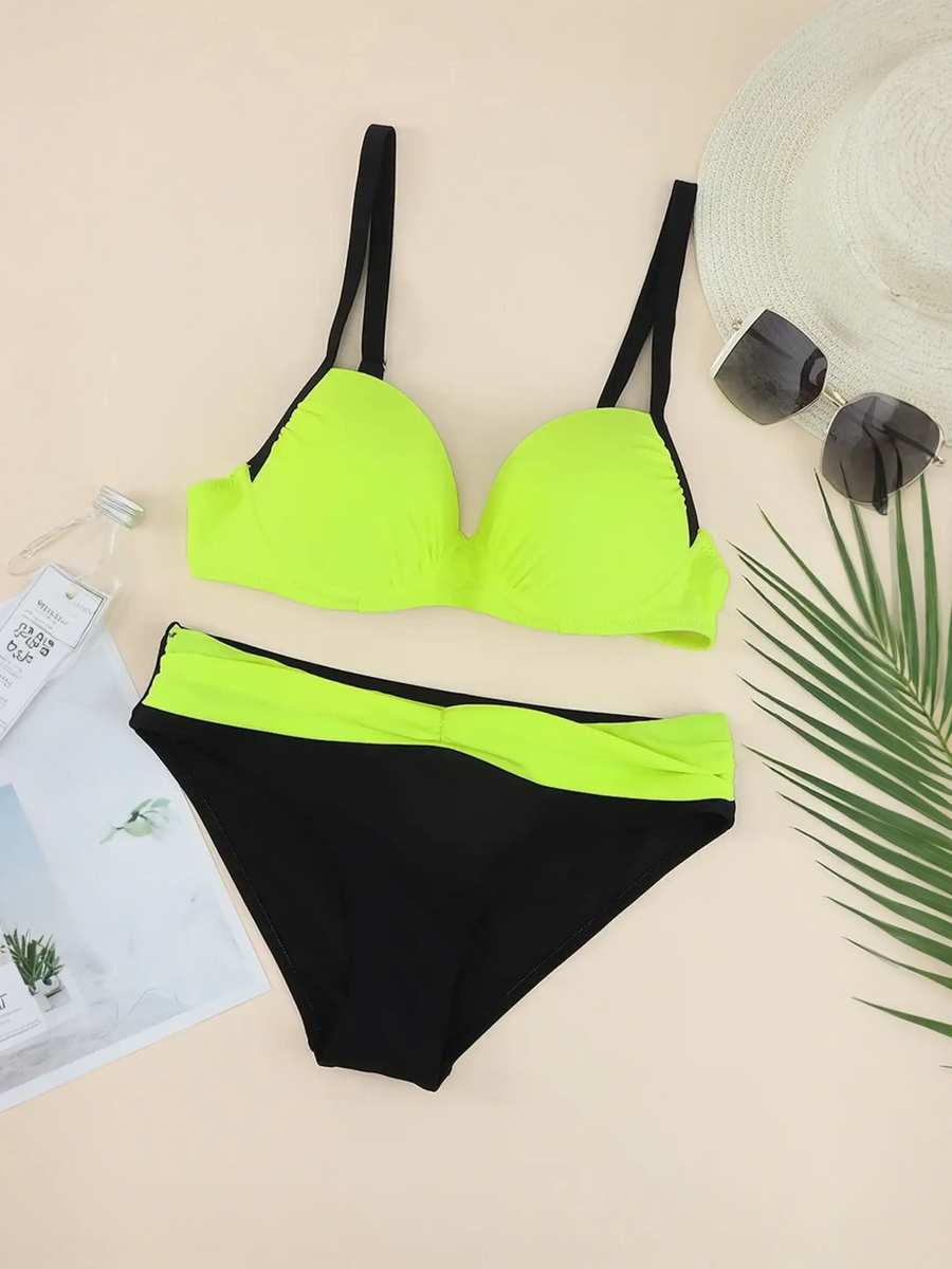 Trendsi neon bikini set with black and bright neon green color block design flat lay with hat sunglasses and magazine