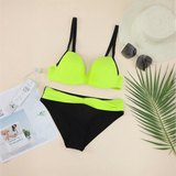 Trendsi neon bikini set with black and bright neon green color block design flat lay with hat sunglasses and magazine