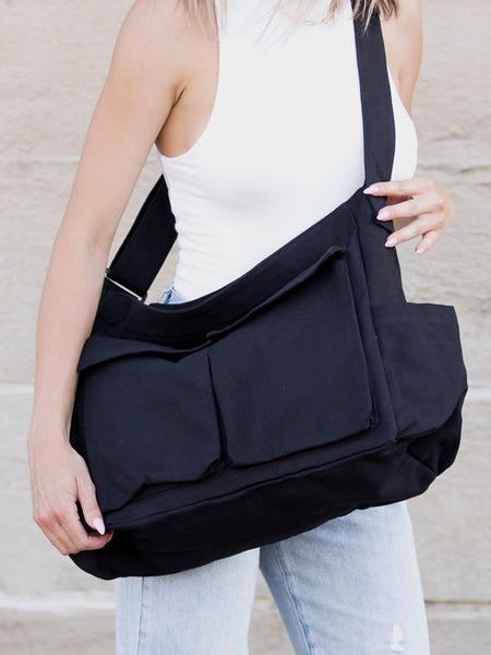 Nova Oversized Canvas Messanger Bag by Babe Beachwaer in black worn crossbody on woman