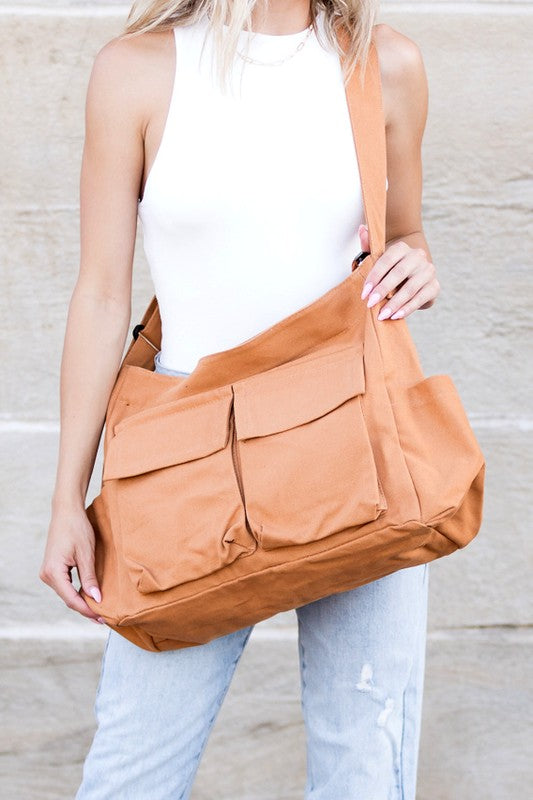 Babe Beachwaer Nova Oversized Canvas Messanger Bag in tan worn crossbody with multiple front pockets