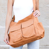 Babe Beachwaer Nova Oversized Canvas Messanger Bag in tan worn crossbody with multiple front pockets