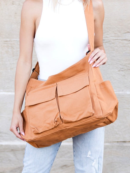 Babe Beachwaer Nova Oversized Canvas Messanger Bag in tan worn crossbody with multiple front pockets