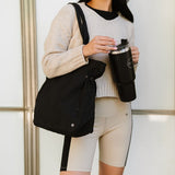 Nylon Lightweight Weekender Gym Bag by Babe Beachwear carried by woman in beige sweater and shorts