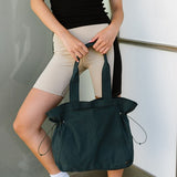 Nylon Lightweight Weekender Gym Bag by Babe Beachwear held by woman in sporty outfit