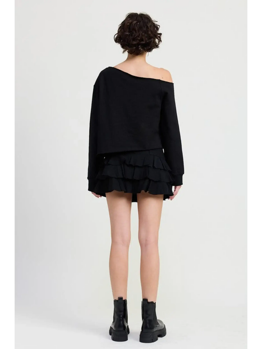 Emory Park off shoulder distressed top black short sleeve worn with black ruffle skirt and boots
