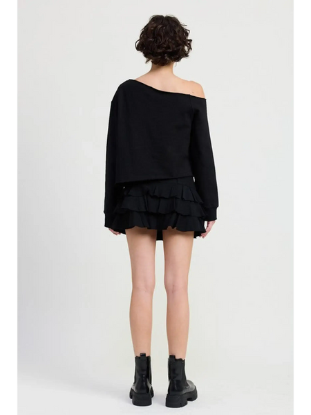 Emory Park off shoulder distressed top black short sleeve worn with black ruffle skirt and boots
